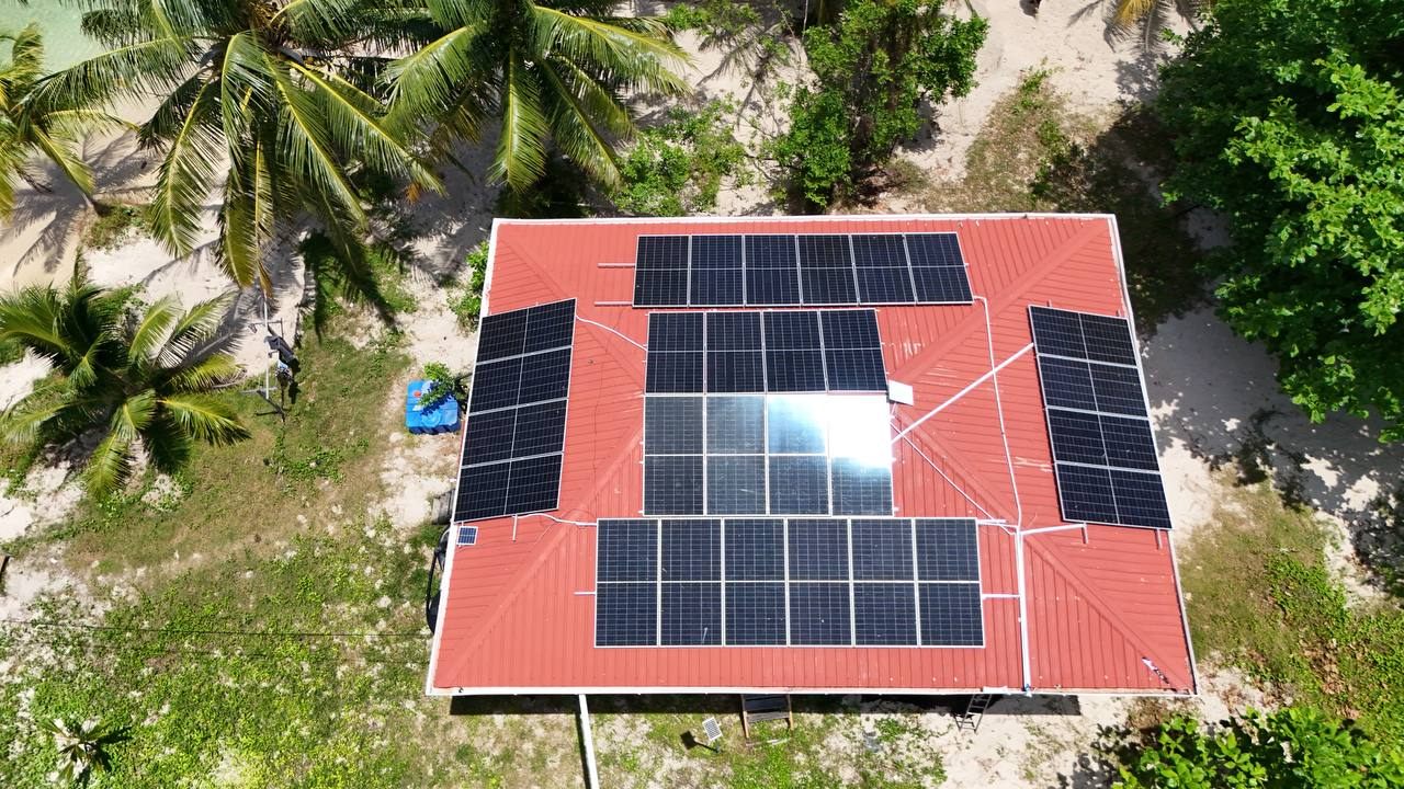 Aerial view of a red roof solar project